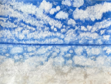 Small clouds in a blue sky, reflected below the horizon